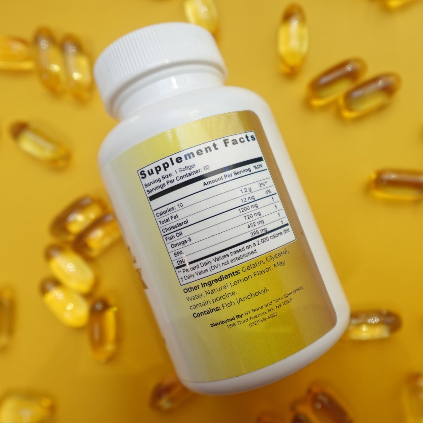 Supplement bottle with yellow capsules on a yellow background