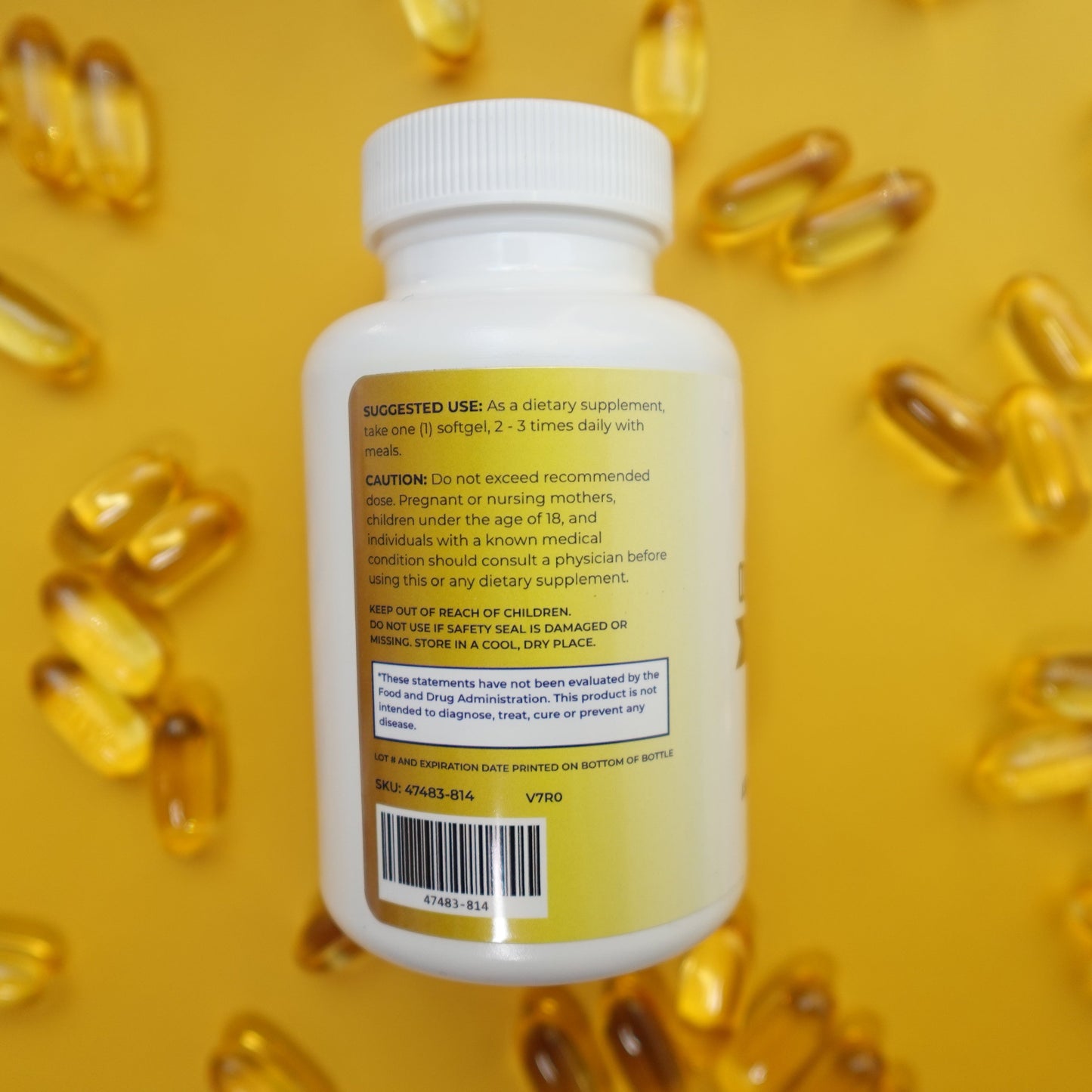 Supplement bottle with yellow capsules on a yellow background