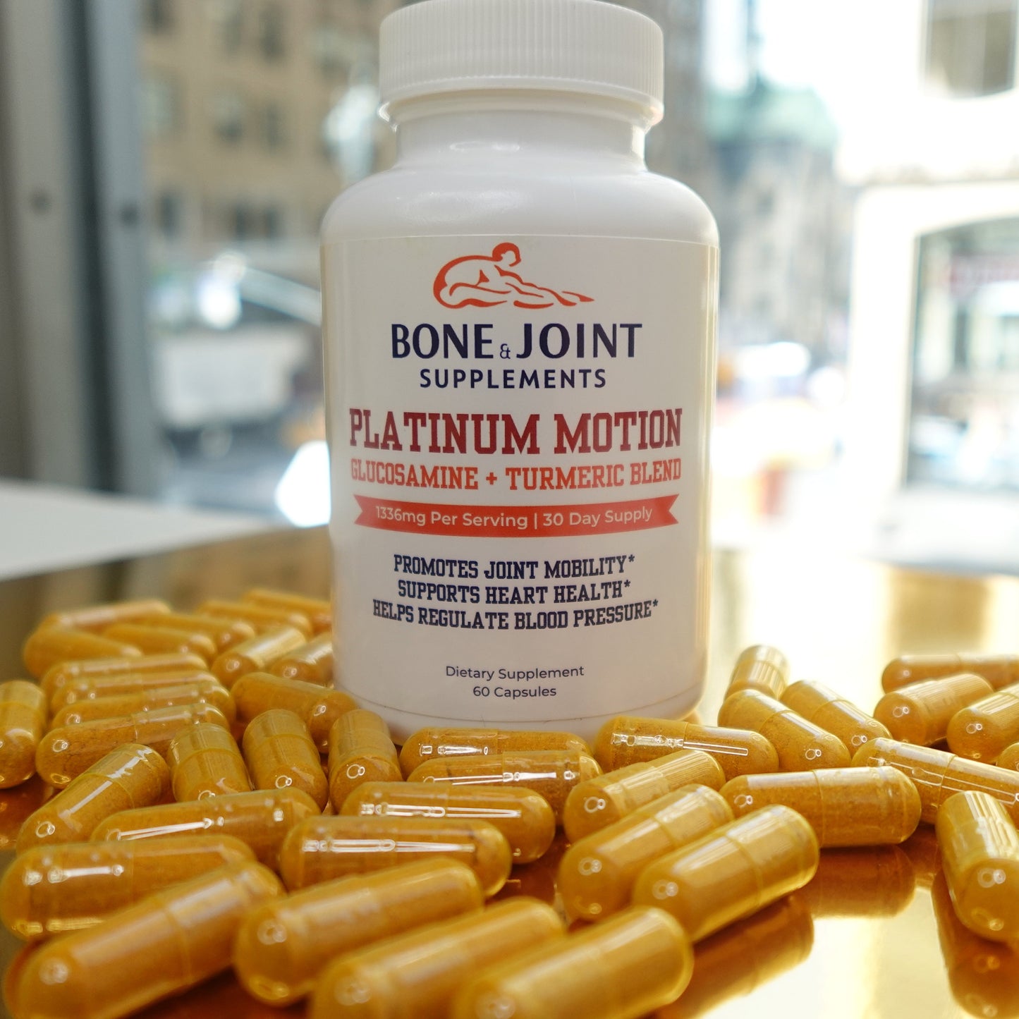 Bone Joint Supplements Platinum Motion bottle with capsules on a reflective surface