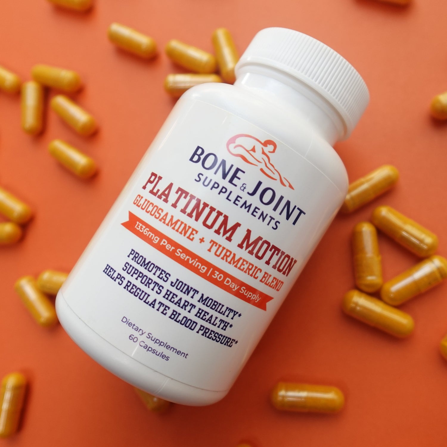 White supplement bottle with red label on an orange background with yellow capsules.